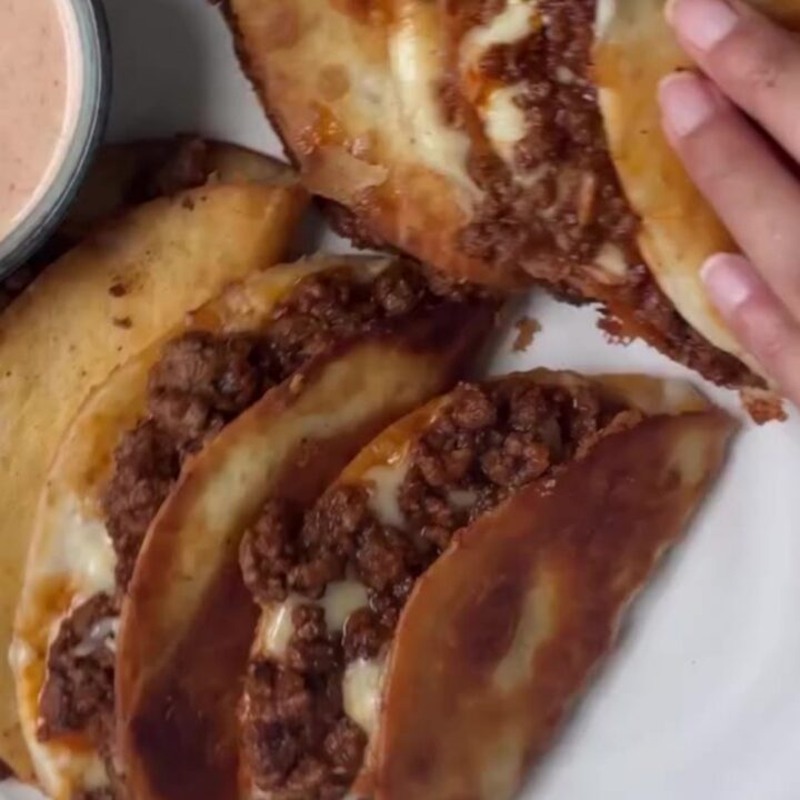 Crispy folded beef taco with melted cheese and pico de gallo