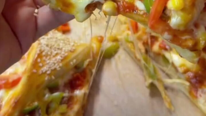 Golden crown pizza with sesame crust and marinara sauce in the center