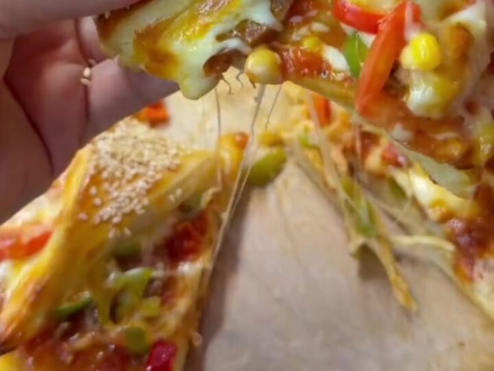 Golden crown pizza with sesame crust and marinara sauce in the center