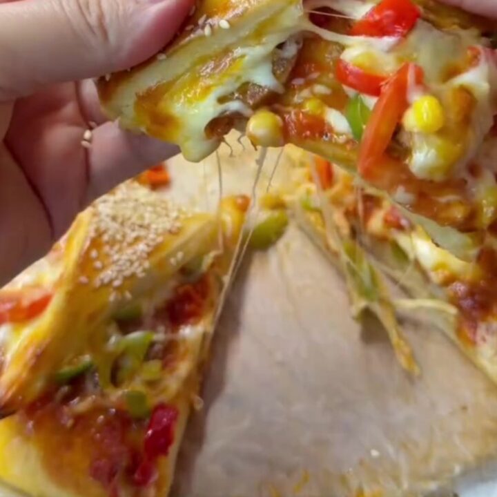 Golden crown pizza with sesame crust and marinara sauce in the center