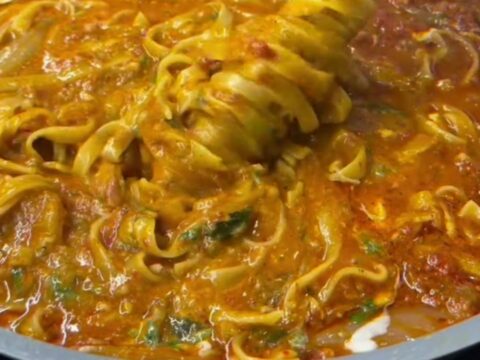 Fettuccine with roasted tomato and vegetable sauce, topped with torn burrata and fresh basil