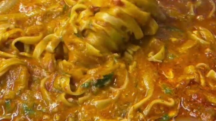 Fettuccine with roasted tomato and vegetable sauce, topped with torn burrata and fresh basil
