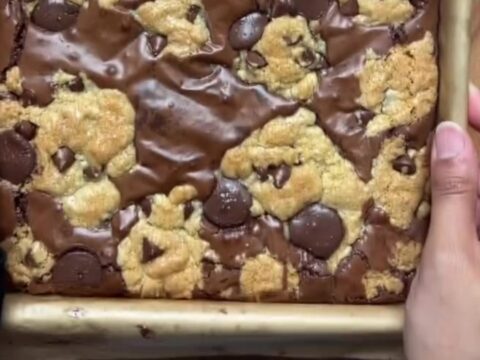Brookies cut into squares, showing fudgy brownie bottom and chewy cookie top with flaky salt.