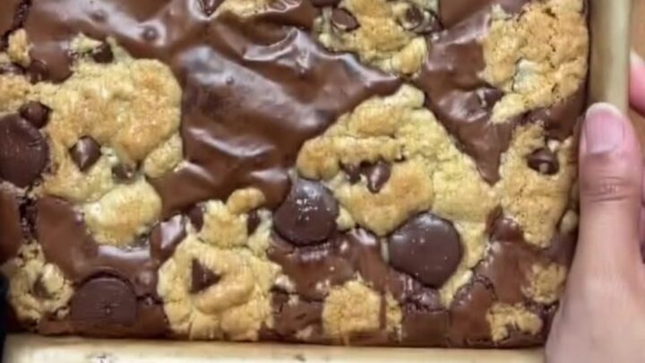 Brookies cut into squares, showing fudgy brownie bottom and chewy cookie top with flaky salt.