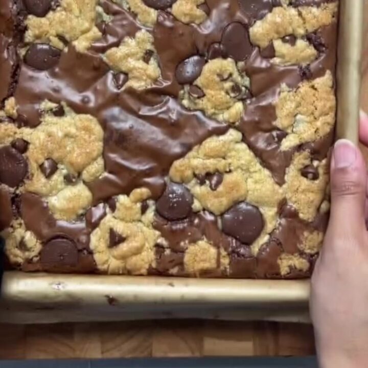 Brookies cut into squares, showing fudgy brownie bottom and chewy cookie top with flaky salt.