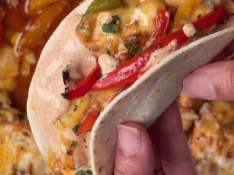 Crispy sheet pan chipotle chicken tacos with melted cheese and sour cream dip