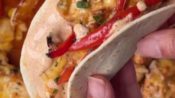 Crispy sheet pan chipotle chicken tacos with melted cheese and sour cream dip