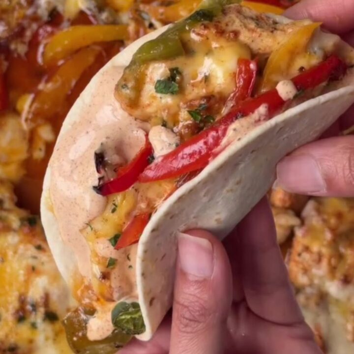 Crispy sheet pan chipotle chicken tacos with melted cheese and sour cream dip