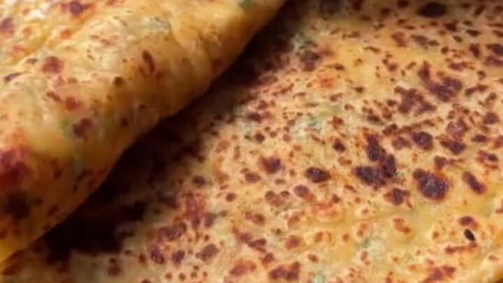 Golden blistered Turkish gözleme sliced into triangles, showing creamy potato and melted cheese filling.