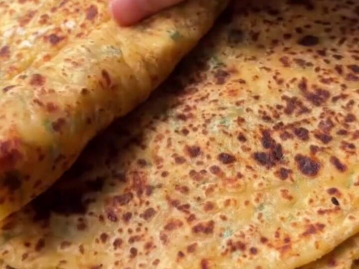 Golden blistered Turkish gözleme sliced into triangles, showing creamy potato and melted cheese filling.