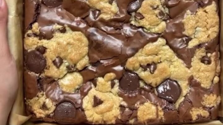 Stack of brookies with visible brownie and cookie layers, topped with flaky sea salt