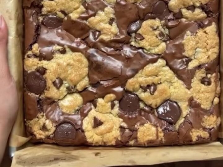 Stack of brookies with visible brownie and cookie layers, topped with flaky sea salt