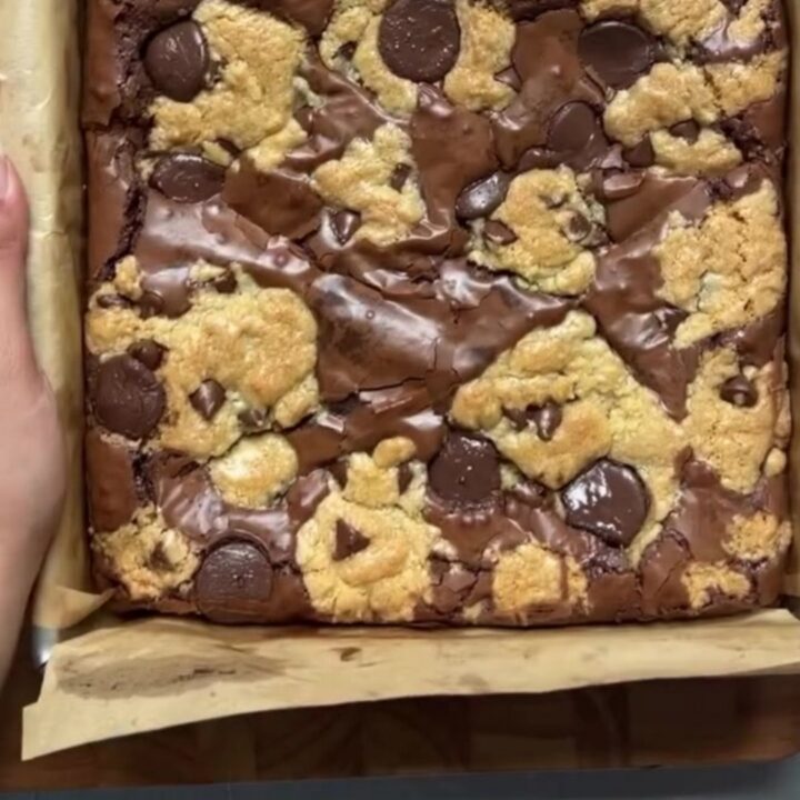 Stack of brookies with visible brownie and cookie layers, topped with flaky sea salt