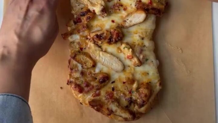 Golden French loaf stuffed with Cajun chicken and melted mozzarella, sliced into thick rounds
