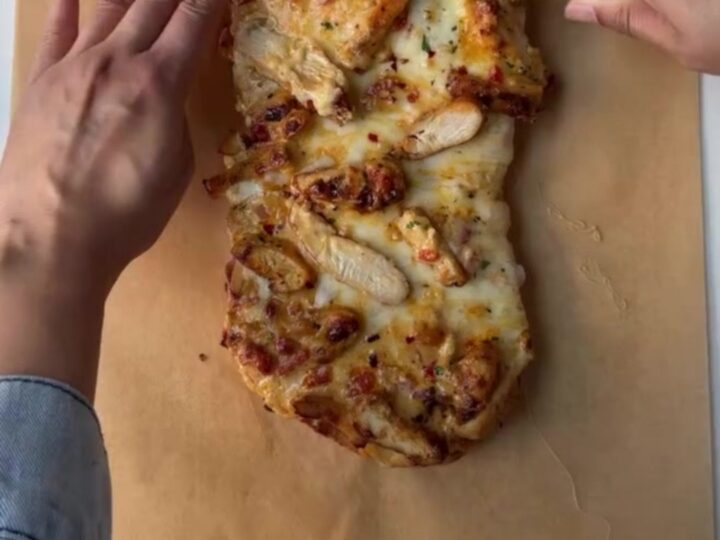 Golden French loaf stuffed with Cajun chicken and melted mozzarella, sliced into thick rounds