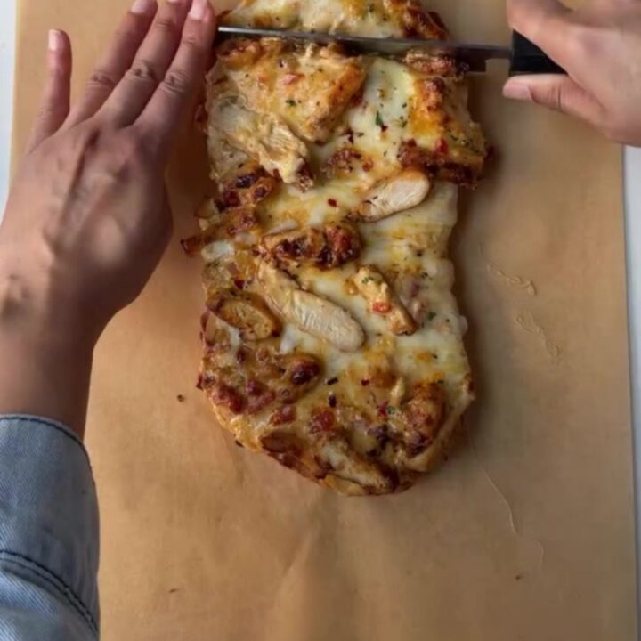 Golden French loaf stuffed with Cajun chicken and melted mozzarella, sliced into thick rounds