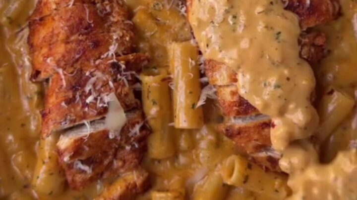 Creamy garlic parmesan chicken fettuccine in a skillet, garnished with parsley