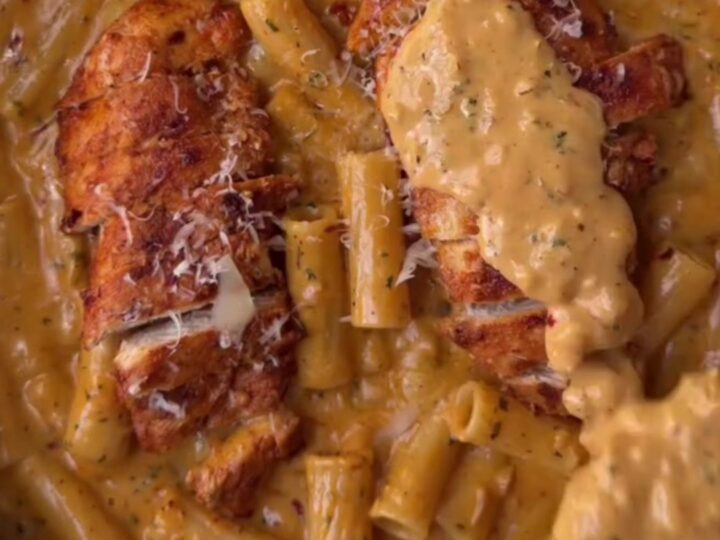 Creamy garlic parmesan chicken fettuccine in a skillet, garnished with parsley