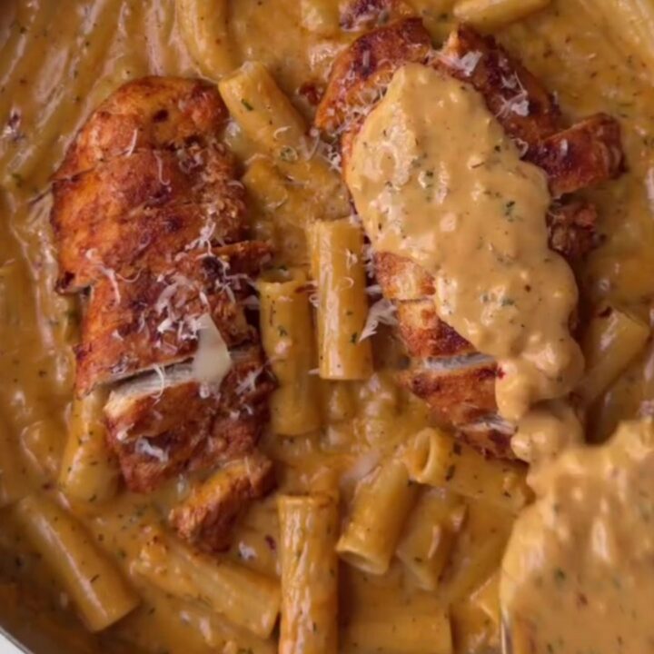 Creamy garlic parmesan chicken fettuccine in a skillet, garnished with parsley