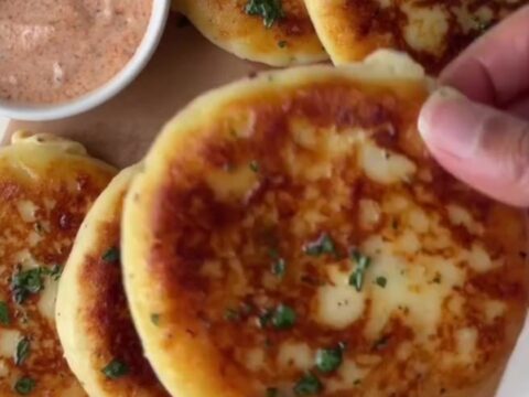 Golden stuffed potato flatbread with molten mozzarella cheese stretching from a slice