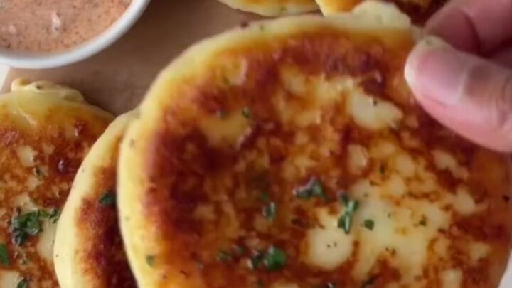 Golden stuffed potato flatbread with molten mozzarella cheese stretching from a slice
