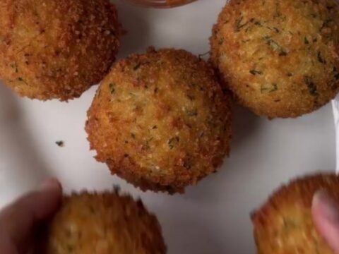 Crispy golden potato cheese balls with a stretchy mozzarella pull, coated in garlic butter and parmesan