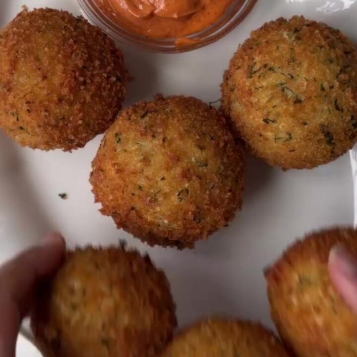 Crispy golden potato cheese balls with a stretchy mozzarella pull, coated in garlic butter and parmesan
