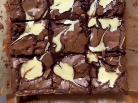 Brown butter cheesecake brownies cut into squares, showing fudgy chocolate and creamy swirls