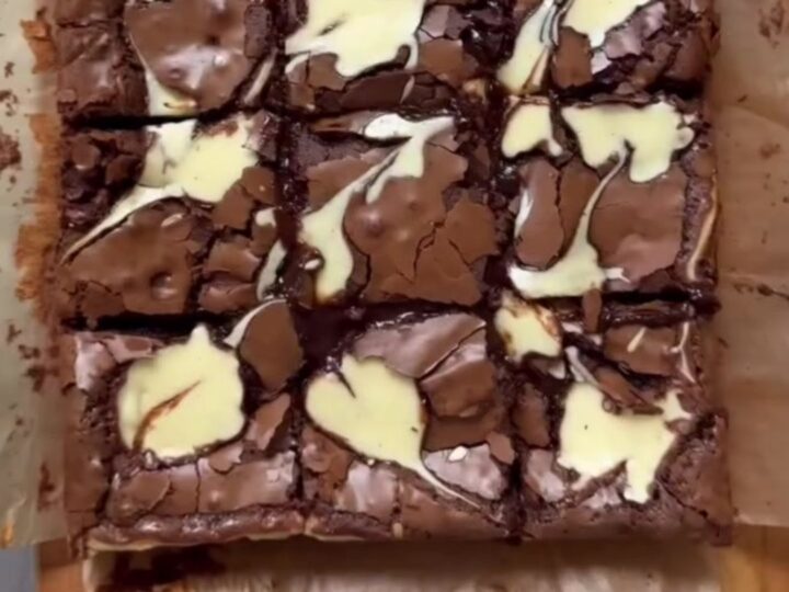 Brown butter cheesecake brownies cut into squares, showing fudgy chocolate and creamy swirls