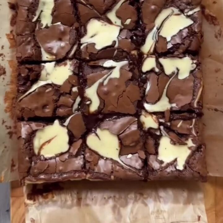 Brown butter cheesecake brownies cut into squares, showing fudgy chocolate and creamy swirls