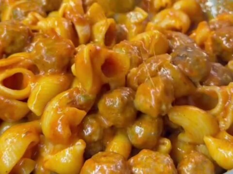 One-pan stuffed shell pasta and meatball bake with melted mozzarella and basil, served in a skillet