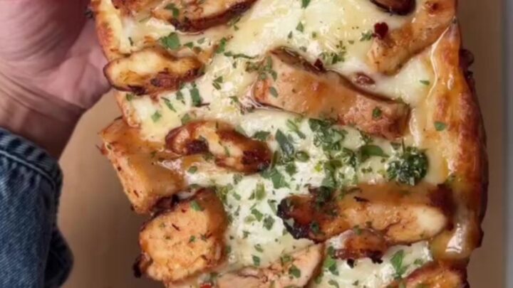 Sliced stuffed baguette with melted mozzarella stretching between pieces
