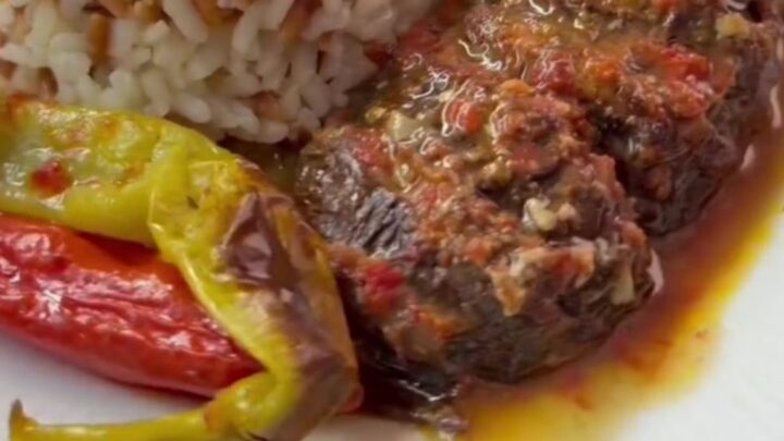Turkish meatball and roasted eggplant casserole in a baking dish with tomato sauce and parsley
