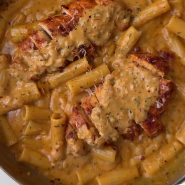 Fettuccine in creamy garlic parmesan sauce with seared chicken cubes and chopped parsley