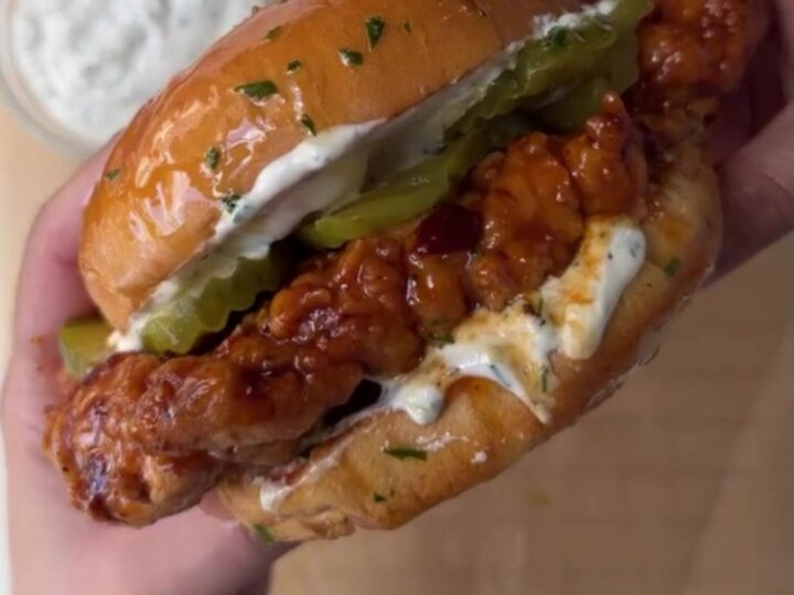 Crispy chicken sandwich with honey chipotle glaze, ranch, and pickles on toasted brioche