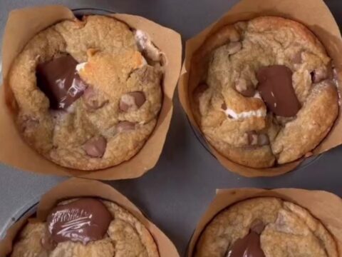 Golden-brown s'mores cookie cups with toasted marshmallow and melted chocolate