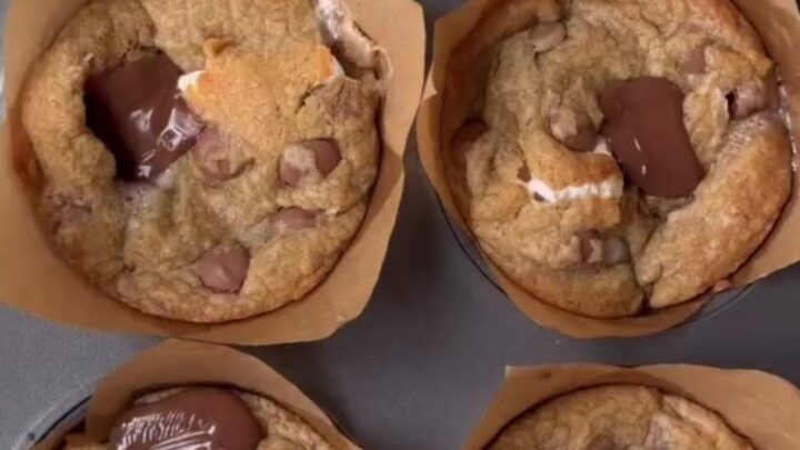 Golden-brown s'mores cookie cups with toasted marshmallow and melted chocolate