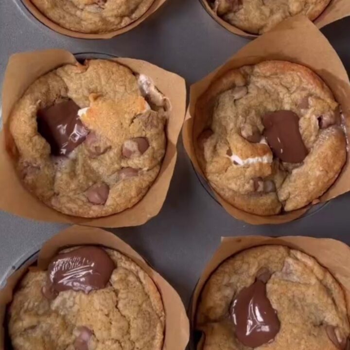 Golden-brown s'mores cookie cups with toasted marshmallow and melted chocolate