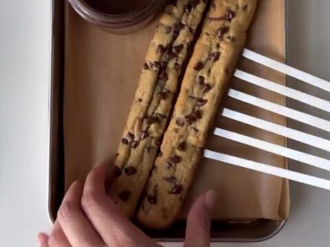 Crispy chocolate chip cookie fries in a red fry carton with warm chocolate fudge dip