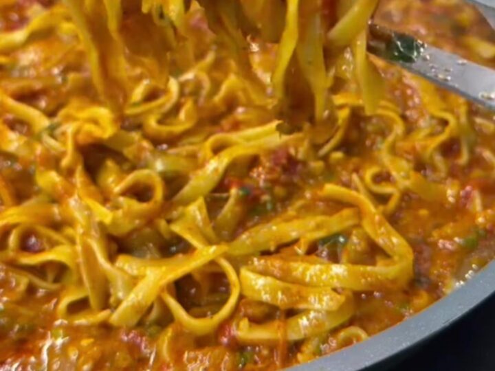 One-pan tagliatelle with tomato, zucchini, and melted mozzarella in a skillet