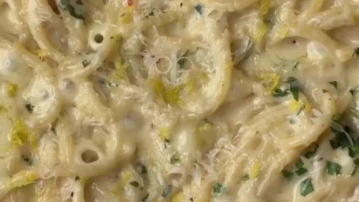 Twirled spaghetti coated in creamy lemon garlic sauce, topped with parsley and black pepper