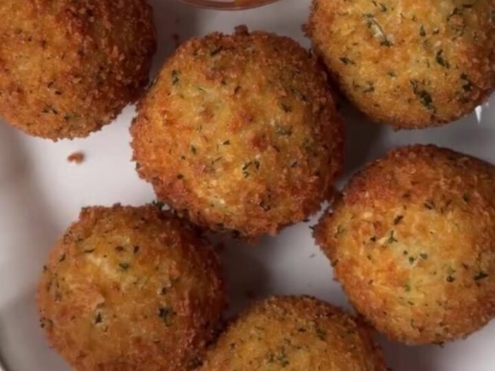 Golden fried potato cheese balls with a cheesy pull, coated in garlic butter and Parmesan.