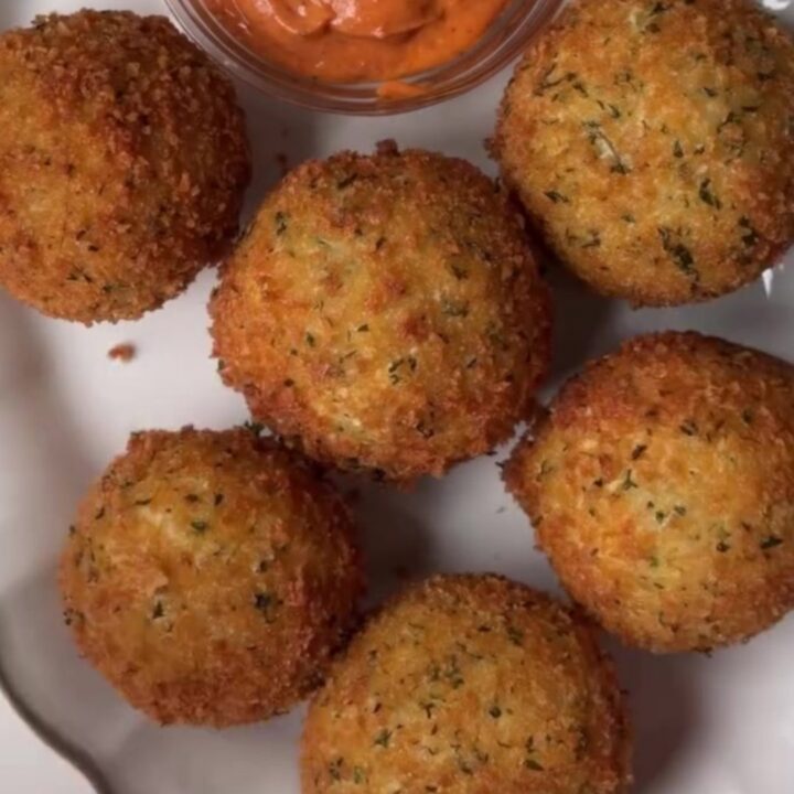 Golden fried potato cheese balls with a cheesy pull, coated in garlic butter and Parmesan.