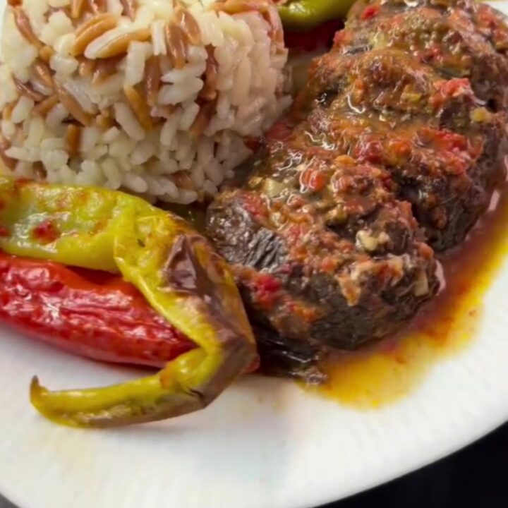 Whole roasted eggplants fanned accordion-style, stuffed with spiced beef and tomato