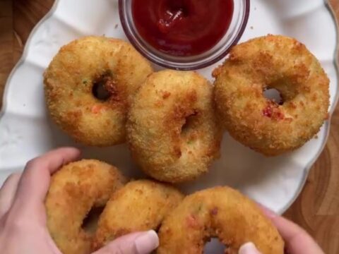 Golden fried potato chicken donuts with a cheese pull and garlic dip