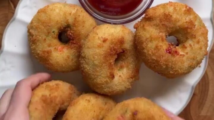 Golden fried potato chicken donuts with a cheese pull and garlic dip