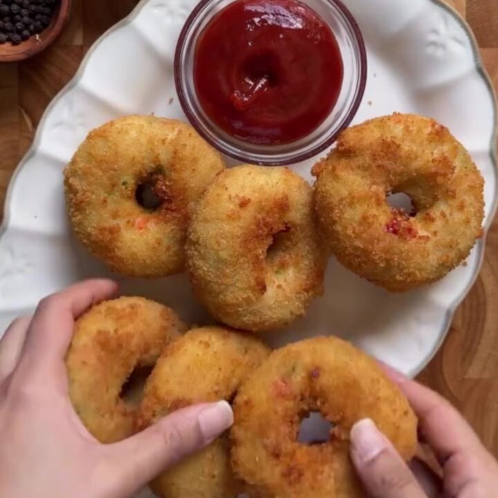 Golden fried potato chicken donuts with a cheese pull and garlic dip
