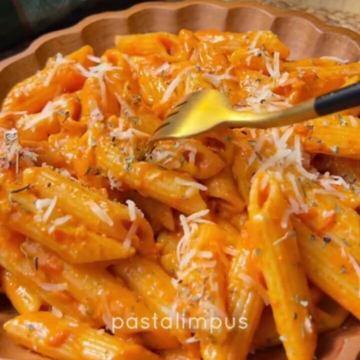 Creamy roasted tomato garlic penne pasta with melted cheese and fresh basil