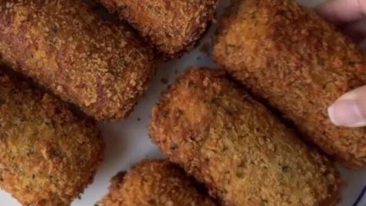 Crispy golden bread rolls stacked on a plate with a bowl of ranch dressing