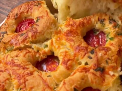 Golden pull-apart bread rolls with melted cheese stretching between them.